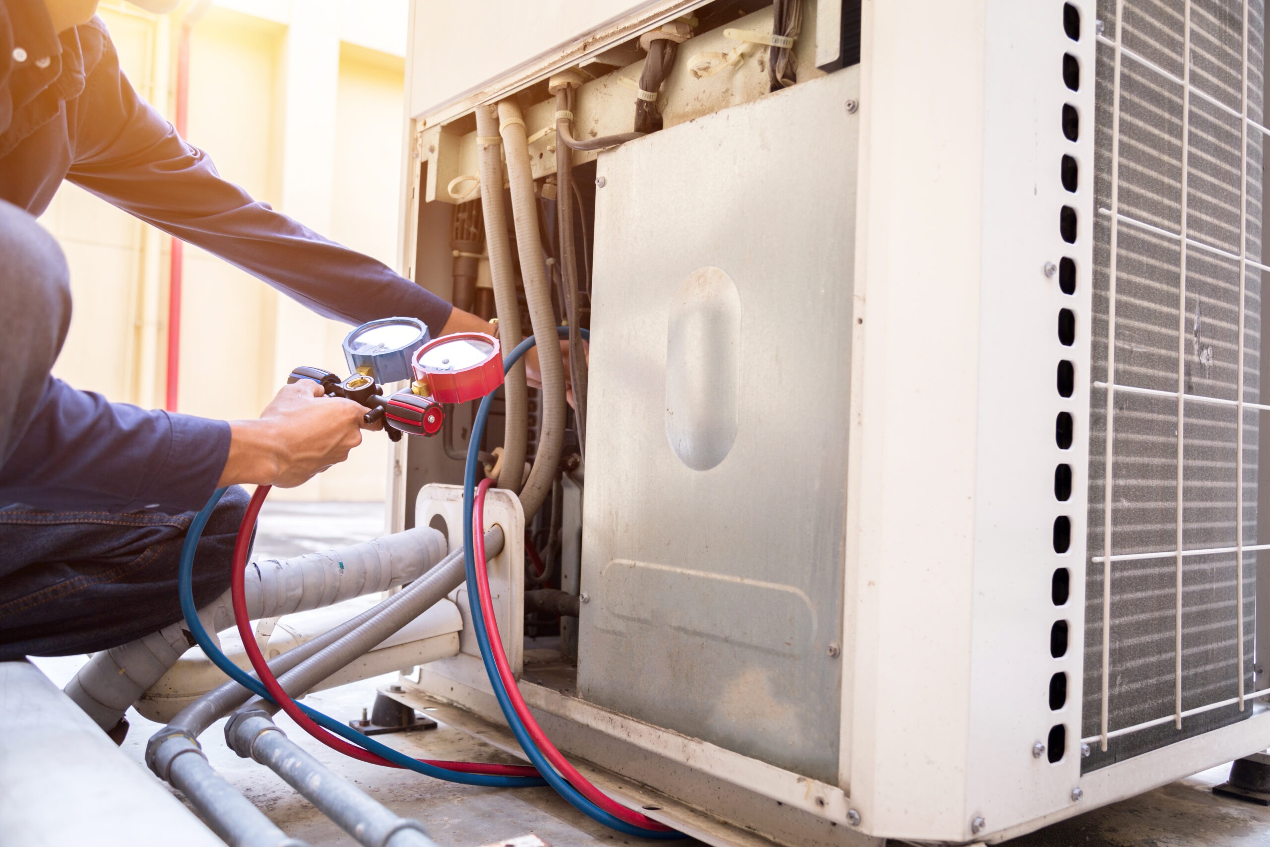 Technician is checking air conditioner ,measuring equipment for