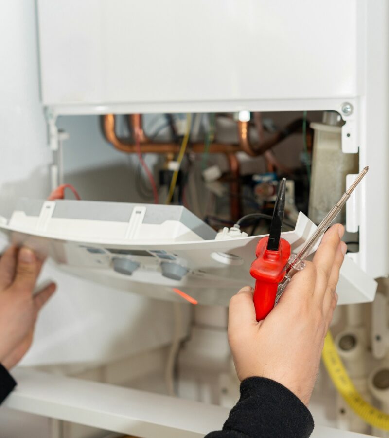 Technician repairing the boiler commercial heating repair essex